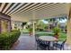 Relaxing patio area with table and chairs, covered pergola, and lush landscaping at 7885 W Flamingo Rd # 1037, Las Vegas, NV 89147