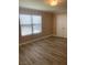 Spacious bedroom with wood-look flooring and large window at 8101 W Flamingo Rd # 2040, Las Vegas, NV 89147