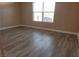 Spacious bedroom with wood-look floors and large window at 8101 W Flamingo Rd # 2040, Las Vegas, NV 89147