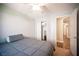 Bedroom with gray bedding, ceiling fan, and a view of the hallway at 8145 Dancing Ave, Las Vegas, NV 89131