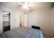 Bedroom with gray bedding, ceiling fan, and TV at 8145 Dancing Ave, Las Vegas, NV 89131