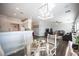 Open concept dining room with glass table and wood chairs at 8145 Dancing Ave, Las Vegas, NV 89131