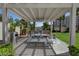 Outdoor grilling area featuring a built-in grill, dining table, benches, shade structure, and palm trees at 8255 Las Vegas Blvd # 611, Las Vegas, NV 89123