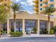 Bright and airy lobby entrance featuring modern architecture with palm trees in front of the building at 8255 Las Vegas Blvd # 611, Las Vegas, NV 89123