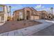 Two-story house with a three-car garage and desert landscaping at 8501 Vivid Violet Ave, Las Vegas, NV 89143