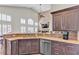 Large kitchen island with sink, granite countertops, and stainless steel appliances at 8501 Vivid Violet Ave, Las Vegas, NV 89143