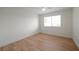 Bright bedroom with light wood laminate flooring and large window at 8600 W Charleston Blvd # 1034, Las Vegas, NV 89117