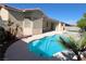 Sparkling swimming pool and spa with desert landscaping create a backyard oasis for relaxation and entertaining at 8682 Waterford Bend St, Las Vegas, NV 89123