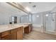 Bathroom featuring dual sinks, separate shower, tub and wood-look floors at 8889 W Torino Ave, Las Vegas, NV 89148