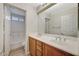 Bright bathroom featuring a double sink vanity and a bathtub with shower at 8889 W Torino Ave, Las Vegas, NV 89148