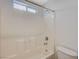 Close-up of a bathtub with a white tiled surround and a small window for natural light at 8889 W Torino Ave, Las Vegas, NV 89148