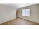 Bright bedroom featuring wood-style laminate flooring and a window with horizontal blinds at 8889 W Torino Ave, Las Vegas, NV 89148