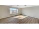 Light bedroom with wood-style laminate flooring and a view outside from a large window at 8889 W Torino Ave, Las Vegas, NV 89148