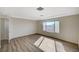 Spacious bedroom featuring wood-style laminate flooring and a large window with a view at 8889 W Torino Ave, Las Vegas, NV 89148