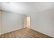 Light-filled bedroom with wood-style laminate flooring and a doorway to another room at 8889 W Torino Ave, Las Vegas, NV 89148