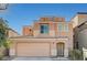 Two-story home featuring a two-car garage and a neutral-colored exterior at 8889 W Torino Ave, Las Vegas, NV 89148