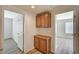 Hallway with wood cabinets offering easy access to multiple rooms at 8889 W Torino Ave, Las Vegas, NV 89148