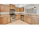 Traditional kitchen features stainless appliances, tile floors and oak cabinets at 8889 W Torino Ave, Las Vegas, NV 89148