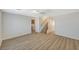 Open-concept living room with wood-look floors and an arched doorway leading to the staircase at 8889 W Torino Ave, Las Vegas, NV 89148