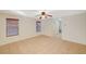 Open living room with tile flooring, recessed lighting, and three large windows at 8889 W Torino Ave, Las Vegas, NV 89148