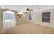 Bright living room featuring tile floors, two windows, and open access to the kitchen at 8889 W Torino Ave, Las Vegas, NV 89148