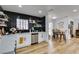 Modern kitchen with white cabinets, black tile backsplash, and stainless steel appliances at 909 Hassett Ave, Las Vegas, NV 89104