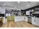 Modern kitchen with white cabinets, black tile backsplash, and stainless steel appliances at 909 Hassett Ave, Las Vegas, NV 89104