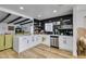 Modern kitchen with white cabinets, black tile backsplash and stainless steel appliances at 909 Hassett Ave, Las Vegas, NV 89104