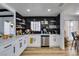 Modern kitchen with white cabinets, quartz countertops, and black tile backsplash at 909 Hassett Ave, Las Vegas, NV 89104