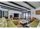 Bright living room with exposed beams, sectional sofa, and wood-look floors at 909 Hassett Ave, Las Vegas, NV 89104