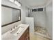 Modern bathroom with a stylish vanity, a glass-enclosed shower, and elegant stone flooring at 9570 Lavarun Ct, Las Vegas, NV 89123