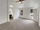 Bright bedroom featuring neutral carpeting and an en-suite bathroom at 9570 Lavarun Ct, Las Vegas, NV 89123