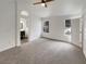 Spacious bedroom featuring neutral carpet, ceiling fan, and natural light from the backyard at 9570 Lavarun Ct, Las Vegas, NV 89123