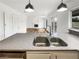 Kitchen with stainless steel sink and fixtures, granite countertops, and adjacent living area at 9570 Lavarun Ct, Las Vegas, NV 89123