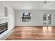 Living room with hardwood floors, fireplace, and sliding doors to patio at 9570 Lavarun Ct, Las Vegas, NV 89123