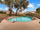 Inviting backyard oasis with a sparkling pool and spa at 9570 Lavarun Ct, Las Vegas, NV 89123