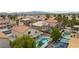 This is an aerial view of homes that have a custom pool and mature landscaping with desert mountain views at 9843 Frosty Canyon Ct, Las Vegas, NV 89183