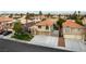 This is an aerial view of a home with a three-car garage, well-maintained landscaping, and a tile roof at 9843 Frosty Canyon Ct, Las Vegas, NV 89183