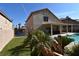 Artificial turf backyard with pool and pergola-covered patio at 9843 Frosty Canyon Ct, Las Vegas, NV 89183