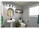 Clean and bright bathroom with pedestal sink and white toilet at 9843 Frosty Canyon Ct, Las Vegas, NV 89183