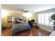 Bright bedroom featuring wood floors and ceiling fan at 9843 Frosty Canyon Ct, Las Vegas, NV 89183