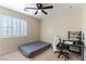 Bedroom featuring carpeted floors, a ceiling fan, and a window with plantation shutters at 9843 Frosty Canyon Ct, Las Vegas, NV 89183