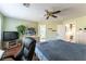 Bright primary bedroom featuring a ceiling fan, wood floors, and a spacious layout with plenty of natural light at 9843 Frosty Canyon Ct, Las Vegas, NV 89183