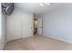 This is a bedroom with a mounted TV, ceiling fan, carpet, and a closet with mirrored sliding doors at 9843 Frosty Canyon Ct, Las Vegas, NV 89183