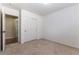 This is a well-lit bedroom with beige carpeting and a large closet with mirrored sliding doors at 9843 Frosty Canyon Ct, Las Vegas, NV 89183