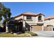 Two-story house with tan exterior, tile roof, and a two-car garage at 9843 Frosty Canyon Ct, Las Vegas, NV 89183