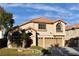 Two-story house with a three-car garage and landscaped yard at 9843 Frosty Canyon Ct, Las Vegas, NV 89183