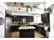 Well-equipped kitchen featuring dark cabinetry, granite counters, and an island at 9843 Frosty Canyon Ct, Las Vegas, NV 89183