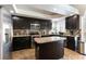 Modern kitchen featuring granite countertops, stainless steel appliances, and dark cabinetry at 9843 Frosty Canyon Ct, Las Vegas, NV 89183