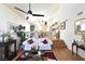 Spacious living room with hardwood floors, a white couch, and a ceiling fan at 9843 Frosty Canyon Ct, Las Vegas, NV 89183